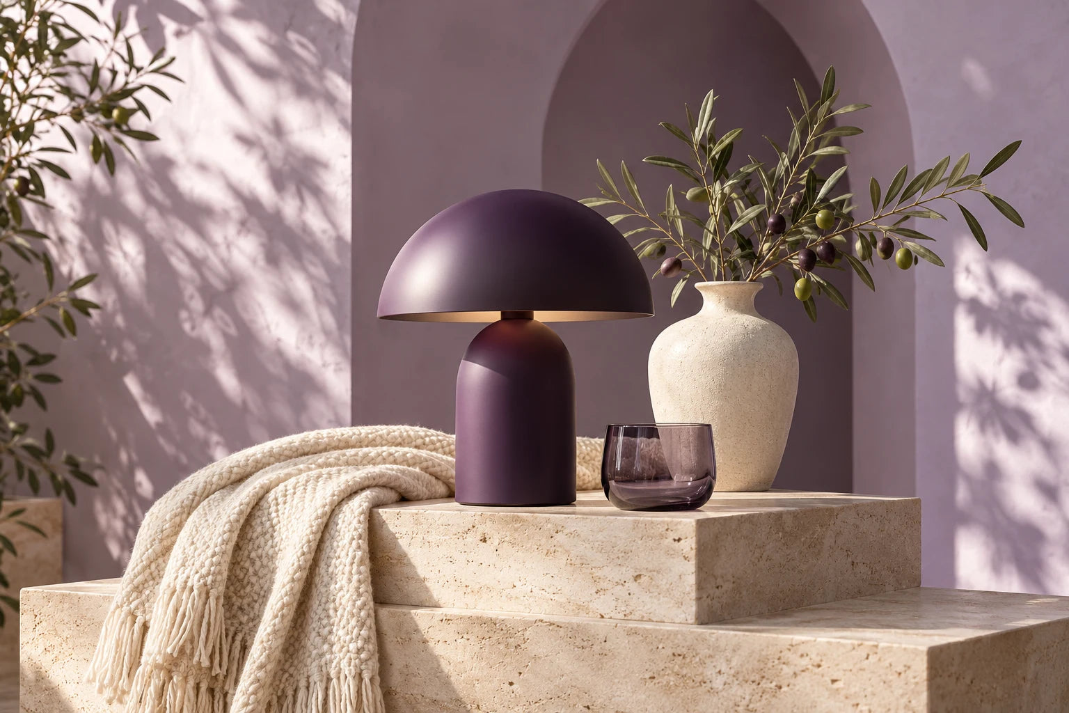Purple lamp, textured ceramics and soft textiles in a sunlit interior. Style inspiration.